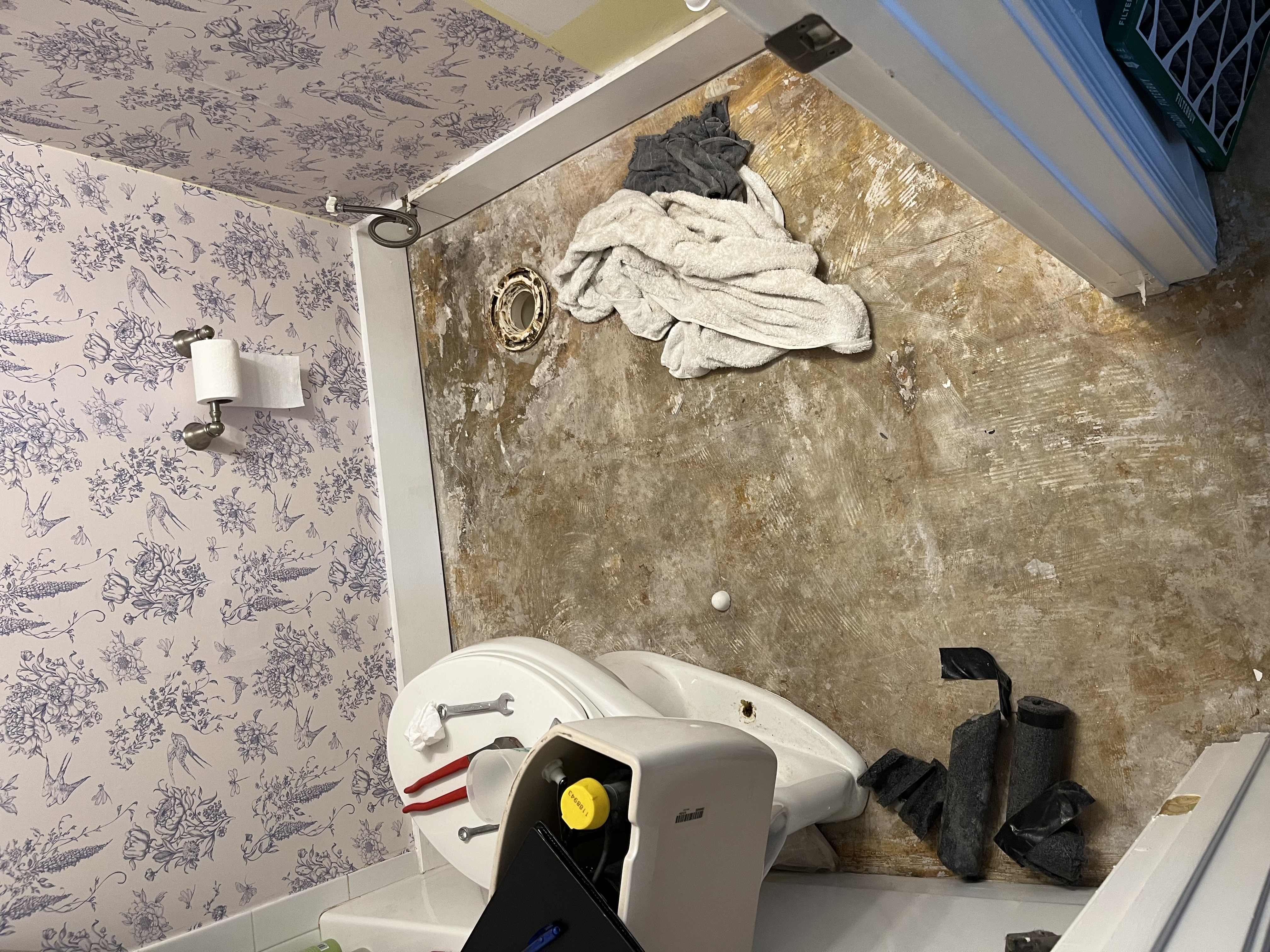 Bathroom floor opened up during preparation before the new tile and toilet installation