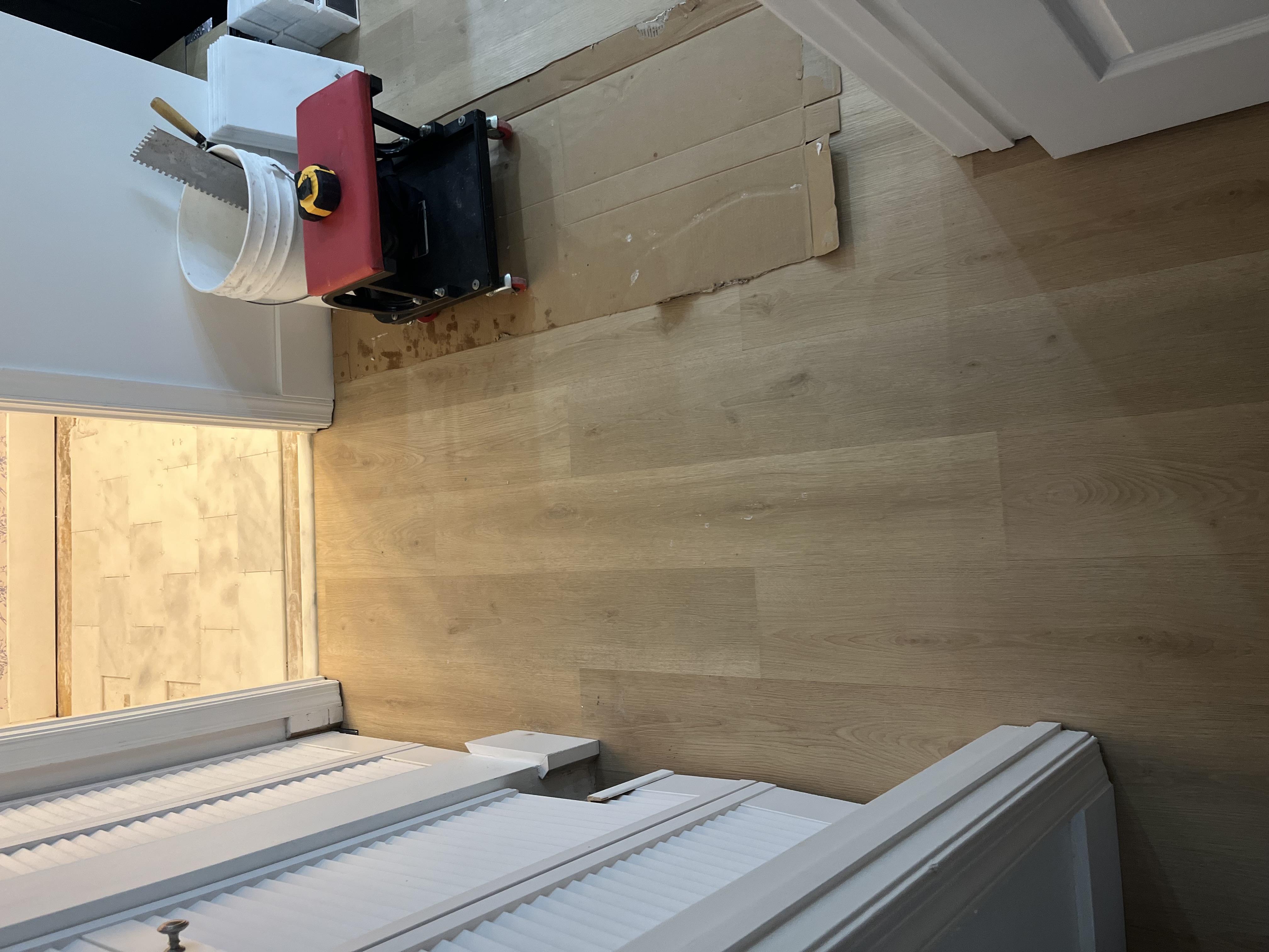 Finished walkway flooring leading cleanly into the bathroom entry