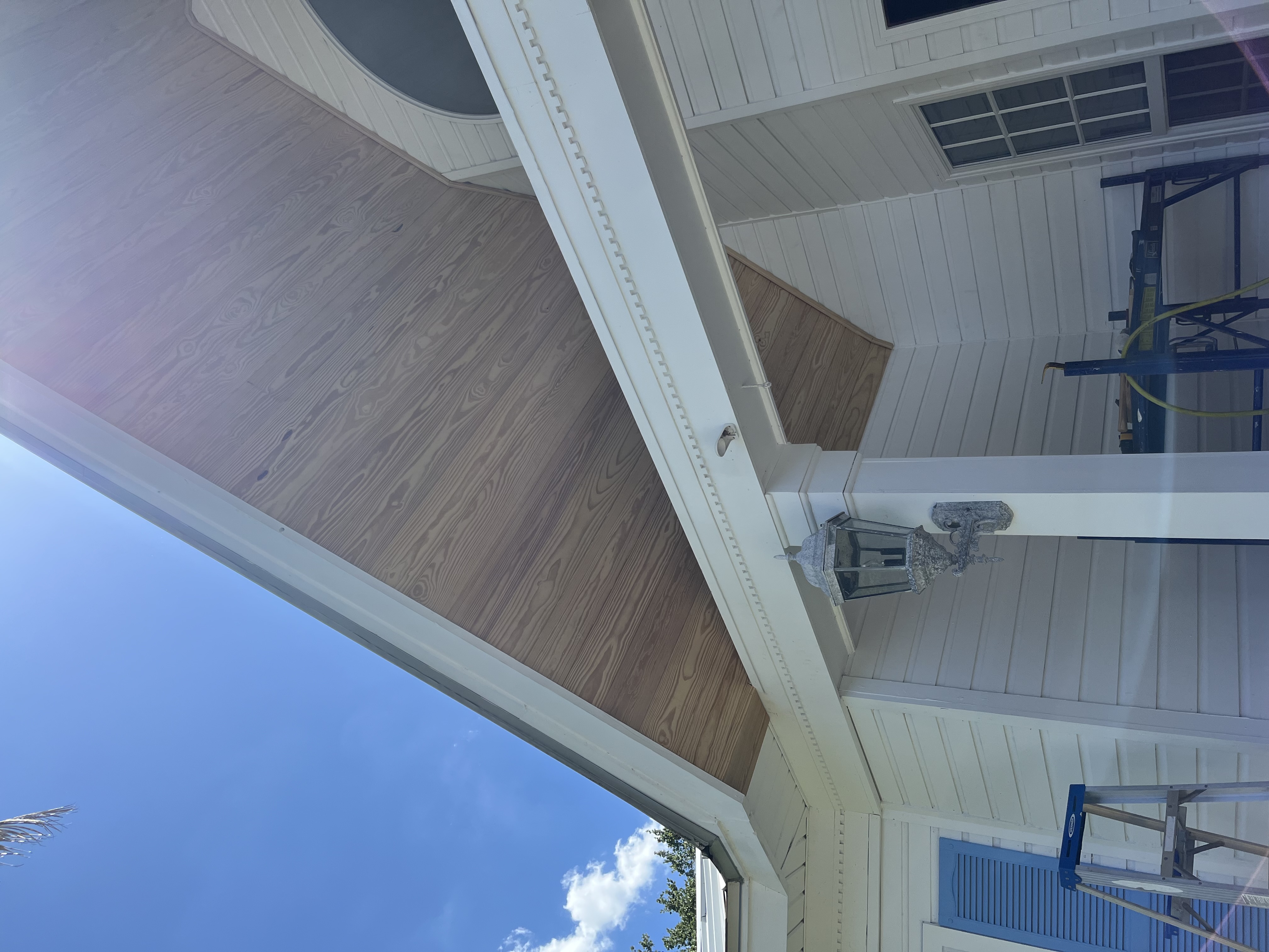 Finished tongue and groove gable ceiling with a rich stained wood look above the front entry