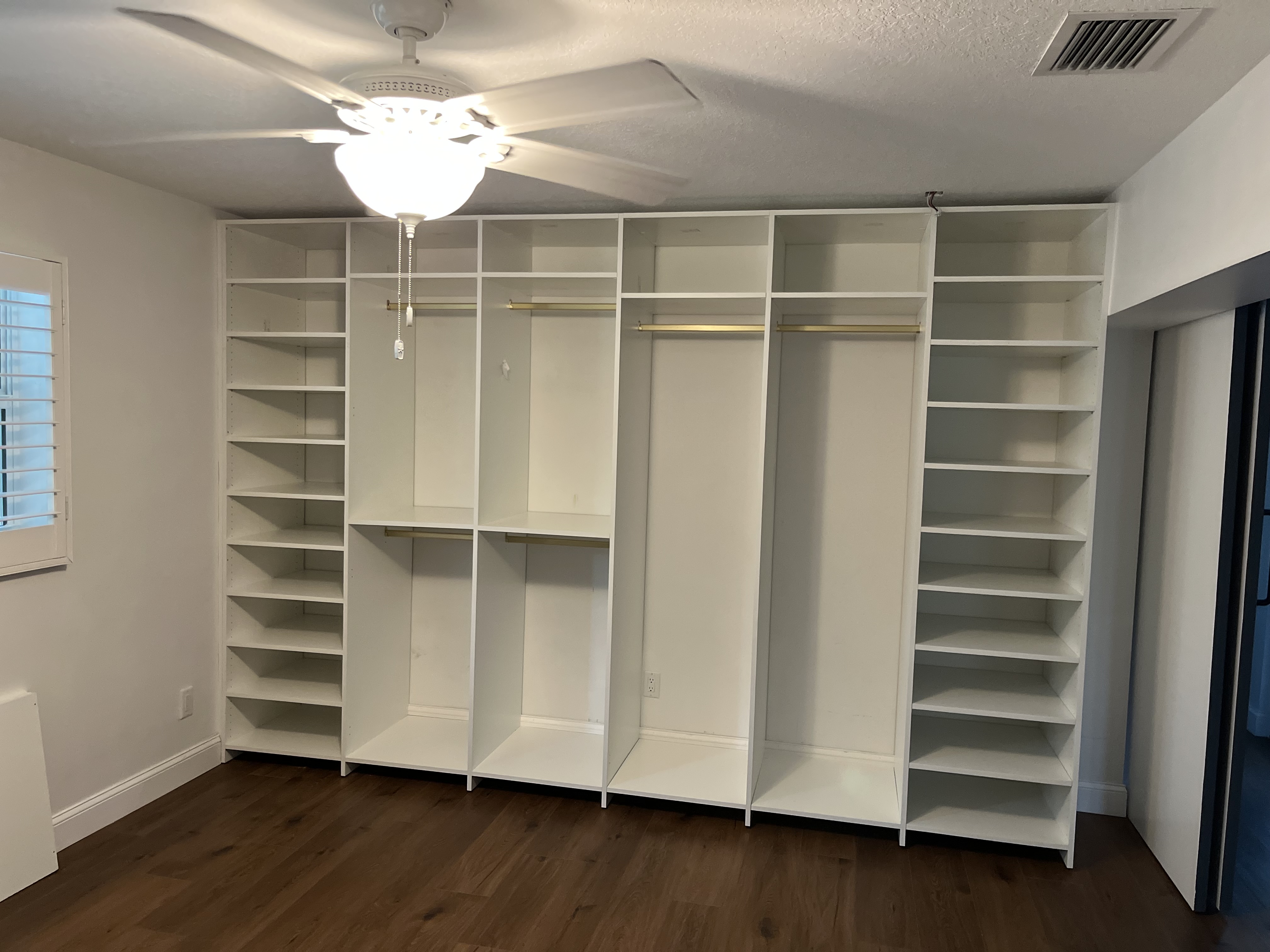 Closet project with open shelving and hanging rods installed