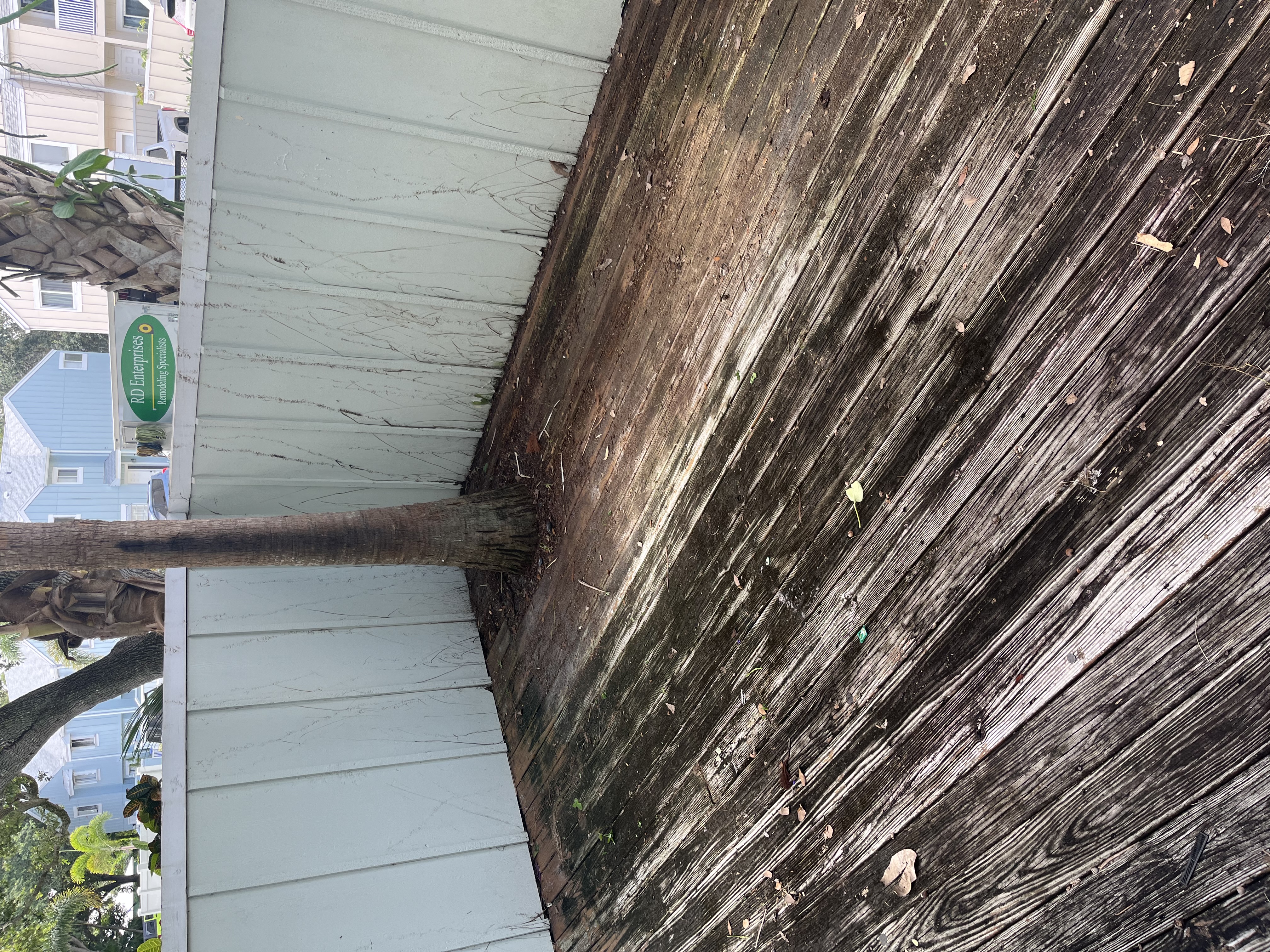 Old weathered wood deck covering the backyard area before demolition began