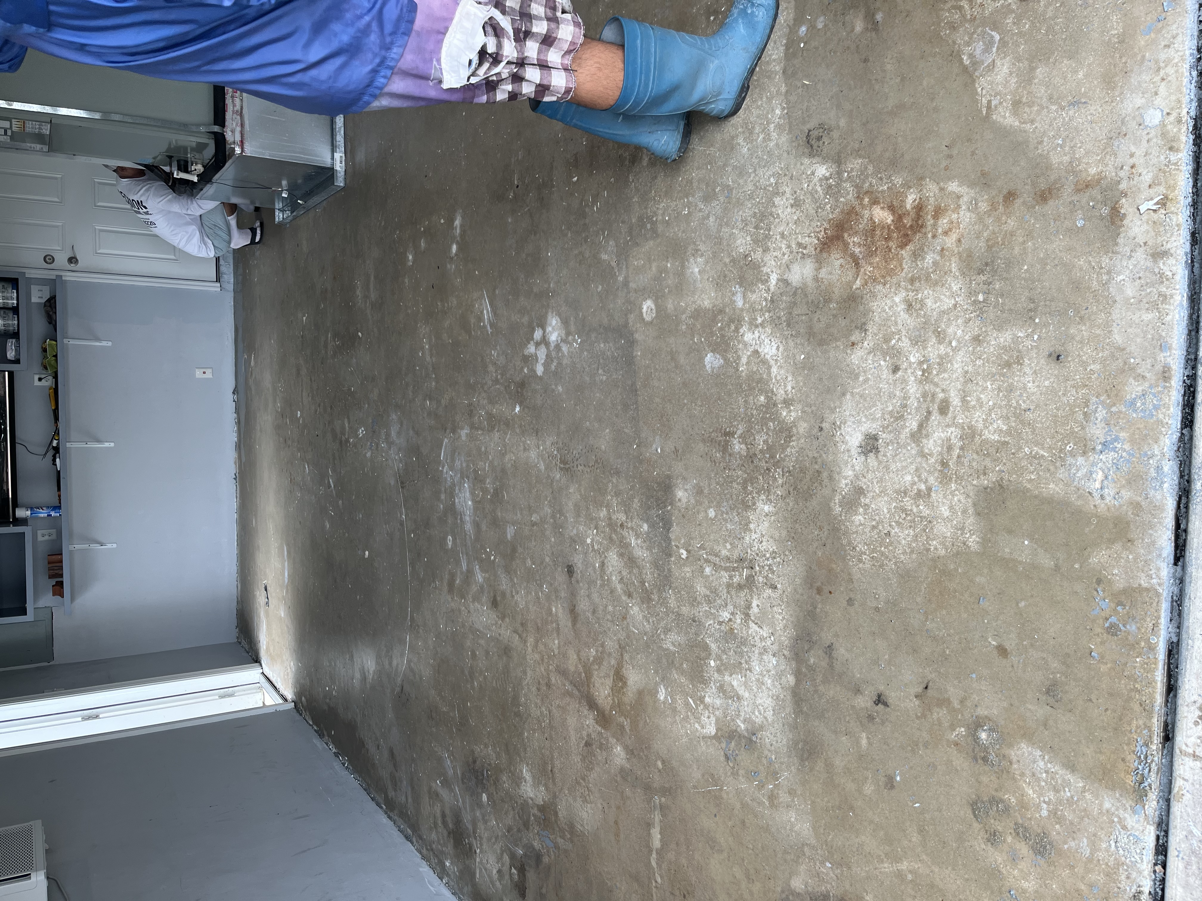 Garage floor before resurfacing with the original worn concrete slab visible