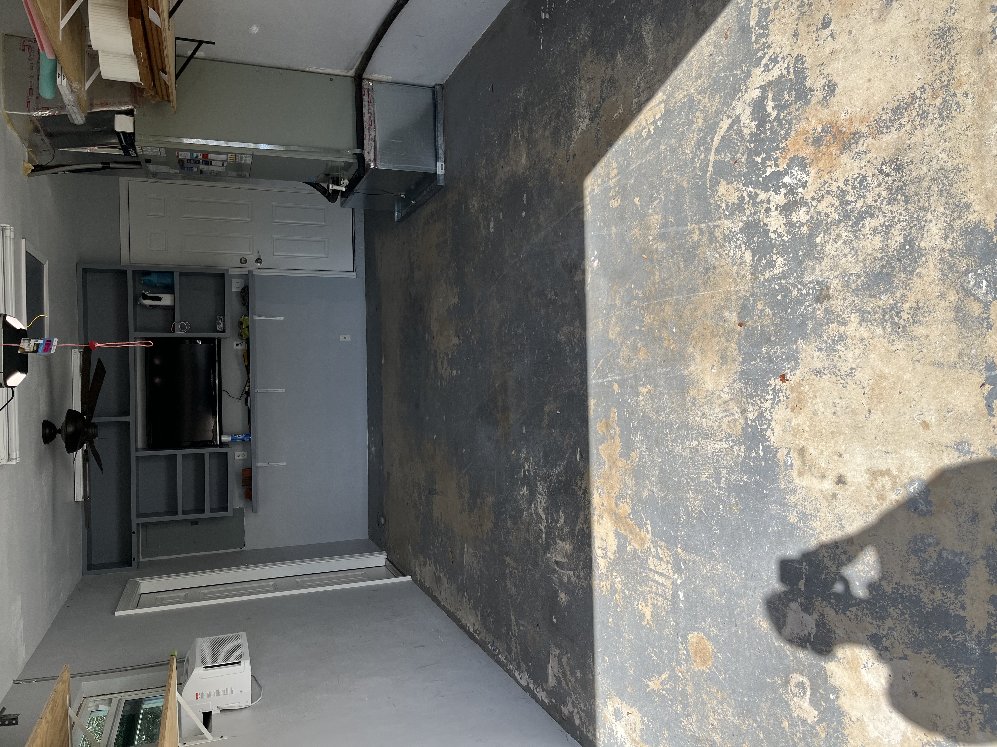 Garage floor during prep work with the old surface partially removed