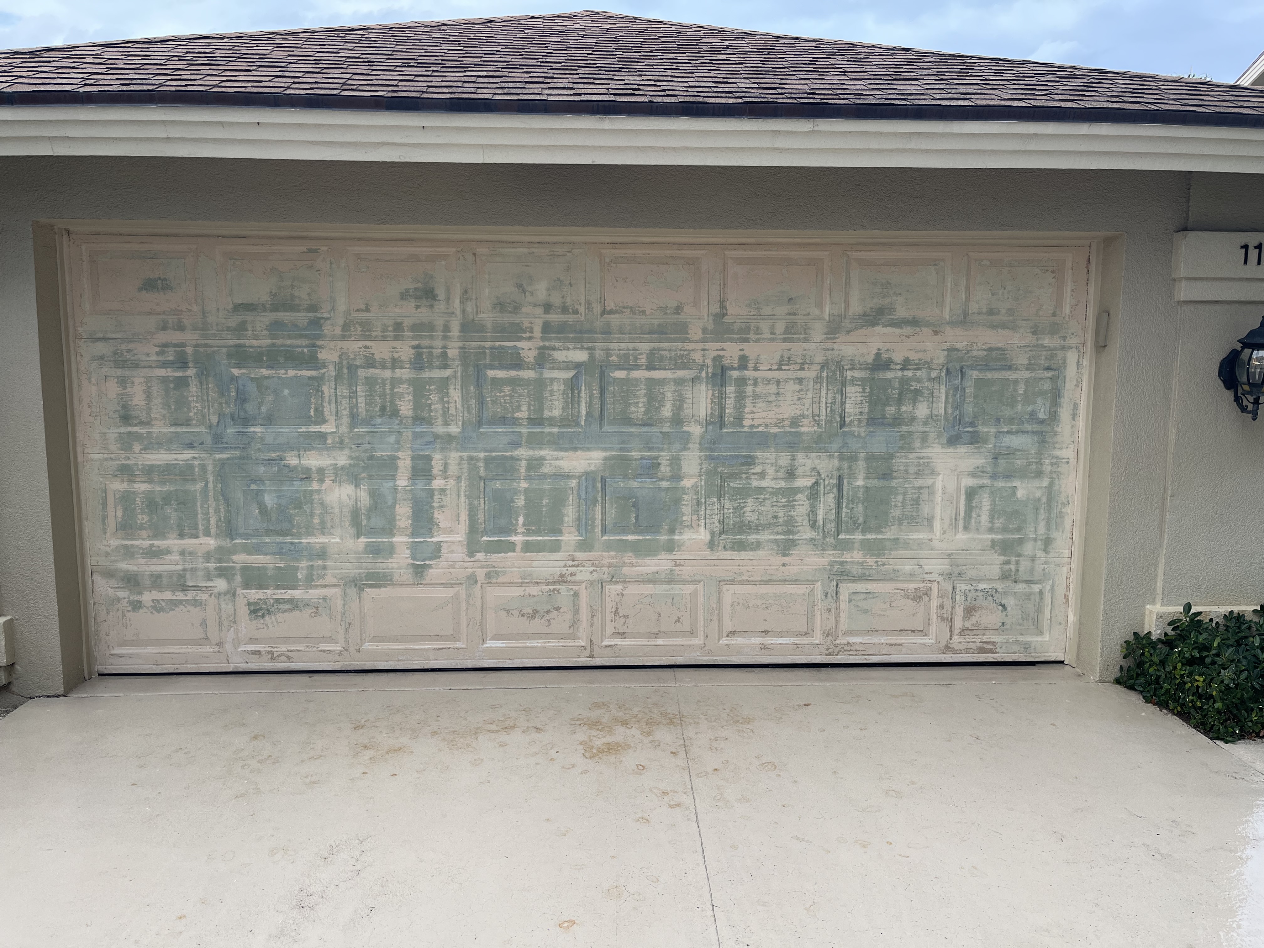 Garage door after more of the original finish has been stripped and prepped