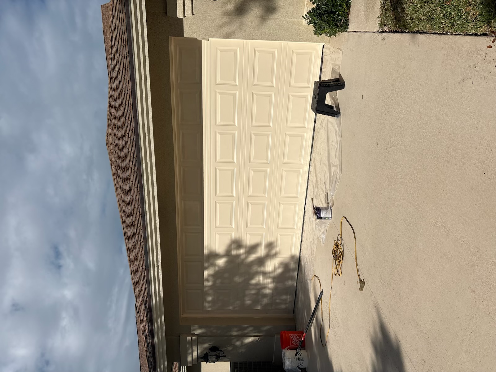 Finished garage door with fresh uniform paint and a clean final appearance