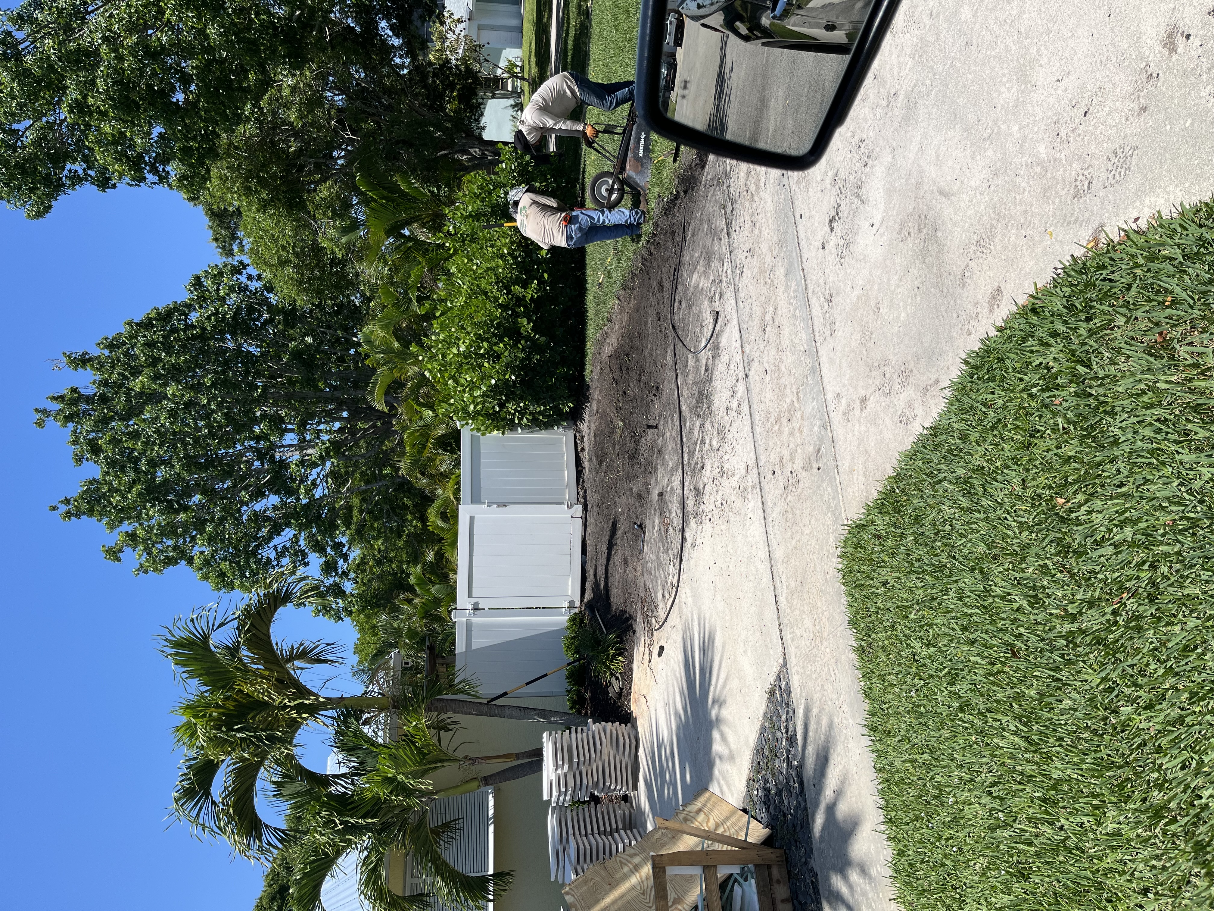 Workers clearing and preparing the side yard area for the new hardscape installation